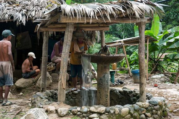 Photo of third-world people in a jungle setting.