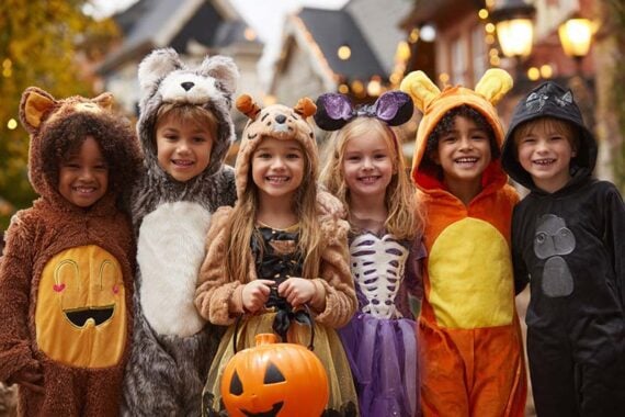 AI image of grade-school-age kids trick or treating. AI image of grade-school-age kids trick or treating.